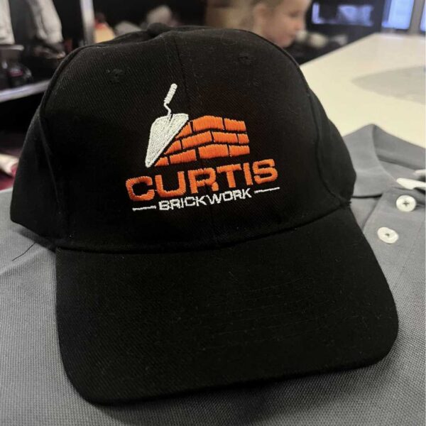 personalised printed embroidered cap hat running workwear team wear with logo printed north west wales orange logo