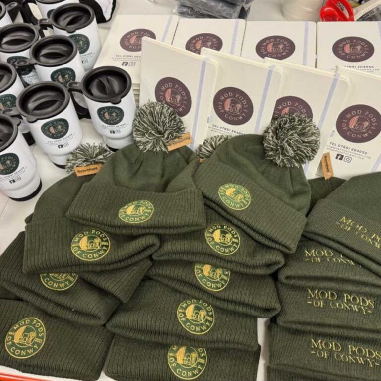 persoanalised branded merch items for event exhibition north west wales affordable high quality logo flyers bvusinesss cards posters signs migs pens lanyards hats pens notebooks travel mugs