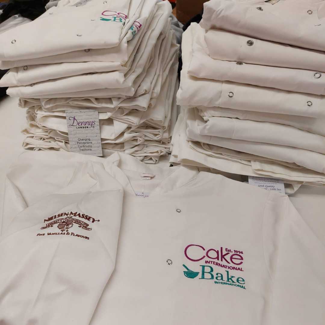 personalised branded chef jacket with logo print embroidered high quality cake bake international custom white pink blue